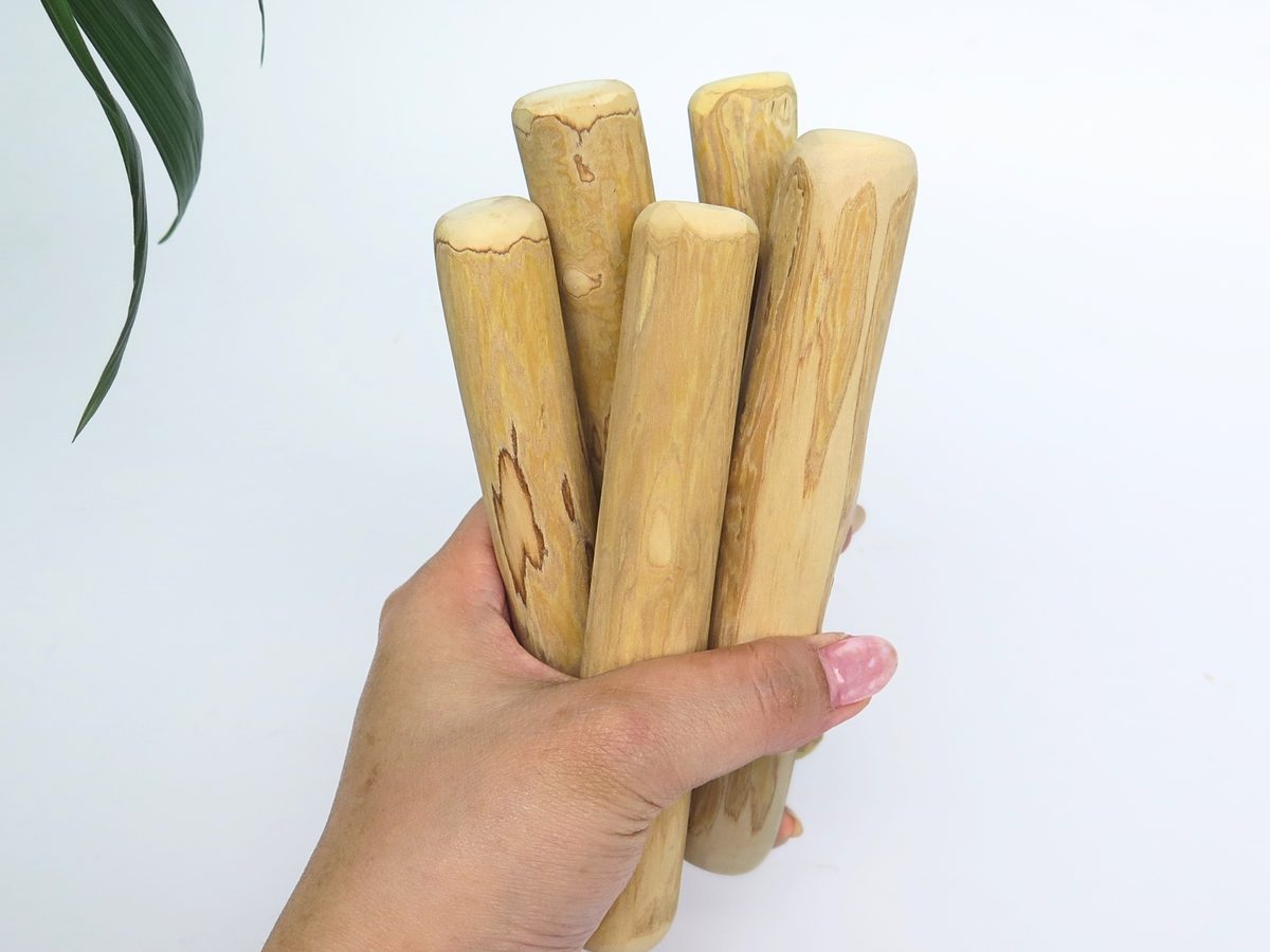A handful of coffee wood dog chew sticks