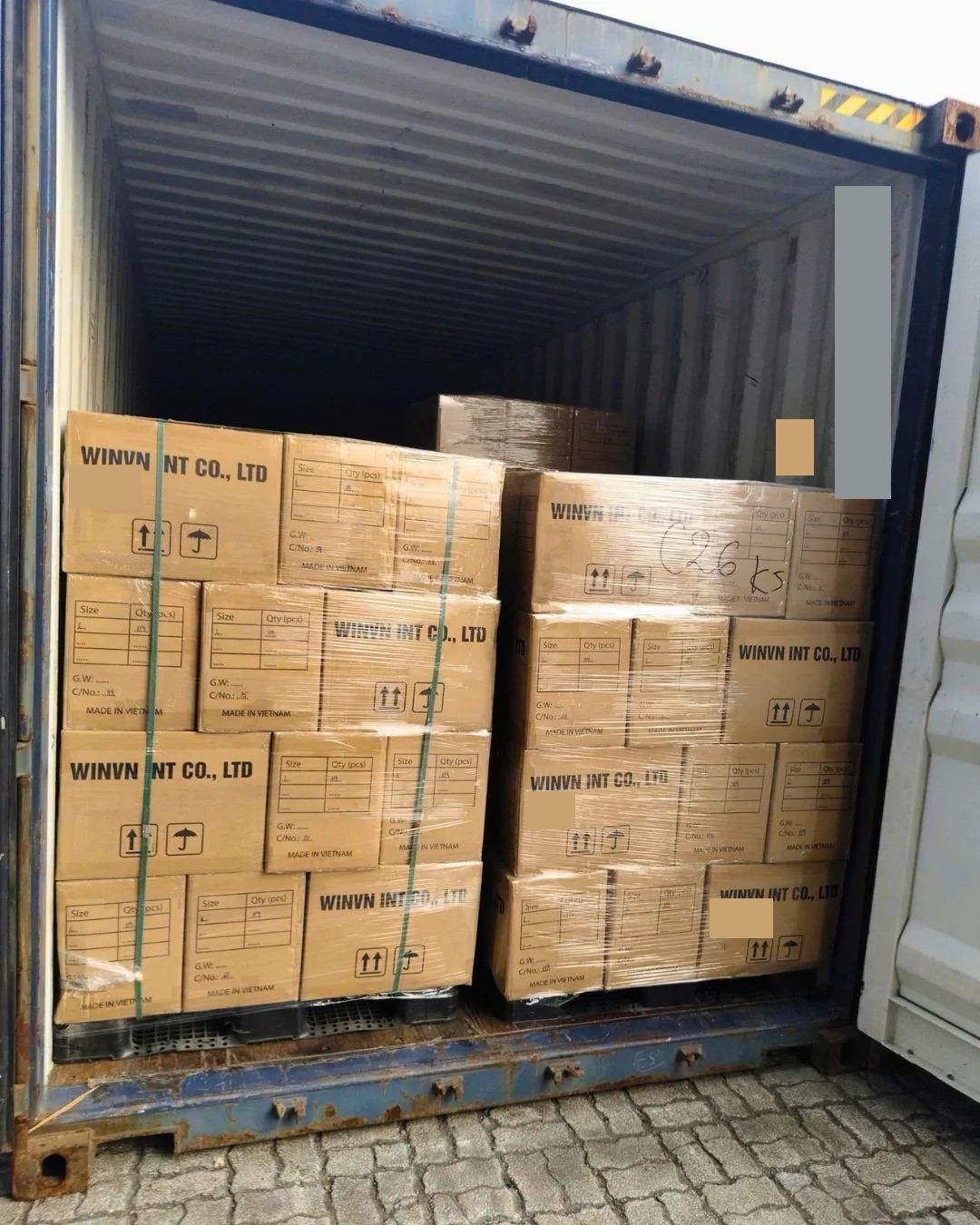 WINVN INT cartons stacked inside a shipping container during loading