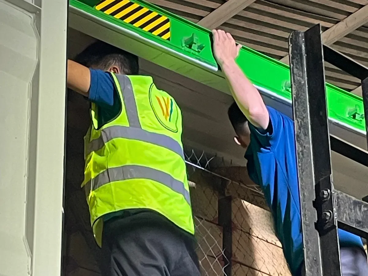 A worker stacking master cartons inside a container during loading